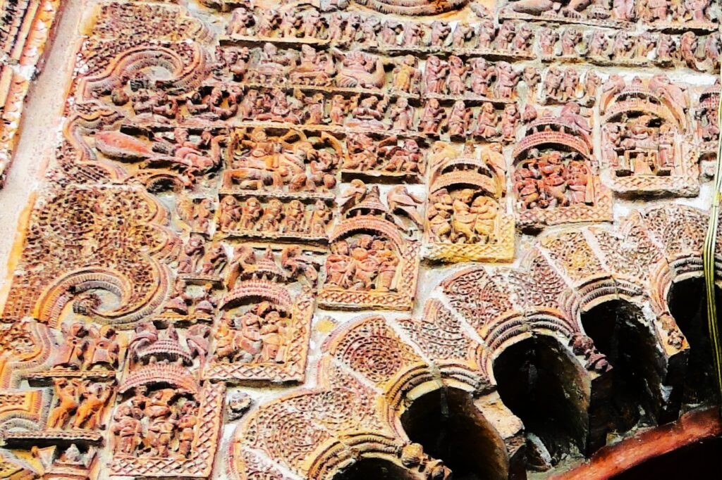 Arch top infused with sculptures depicting Krishna's life