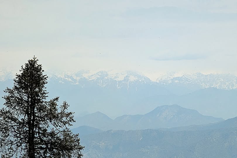 View of the Garhwal Himalayan mountain range, including peaks like Bandarpunch and Swargarohini, from 9,000 feet.