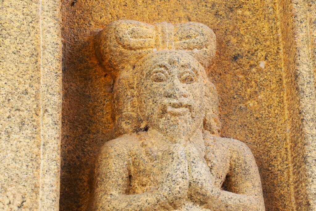 Male figures with structured top knot hairstyle