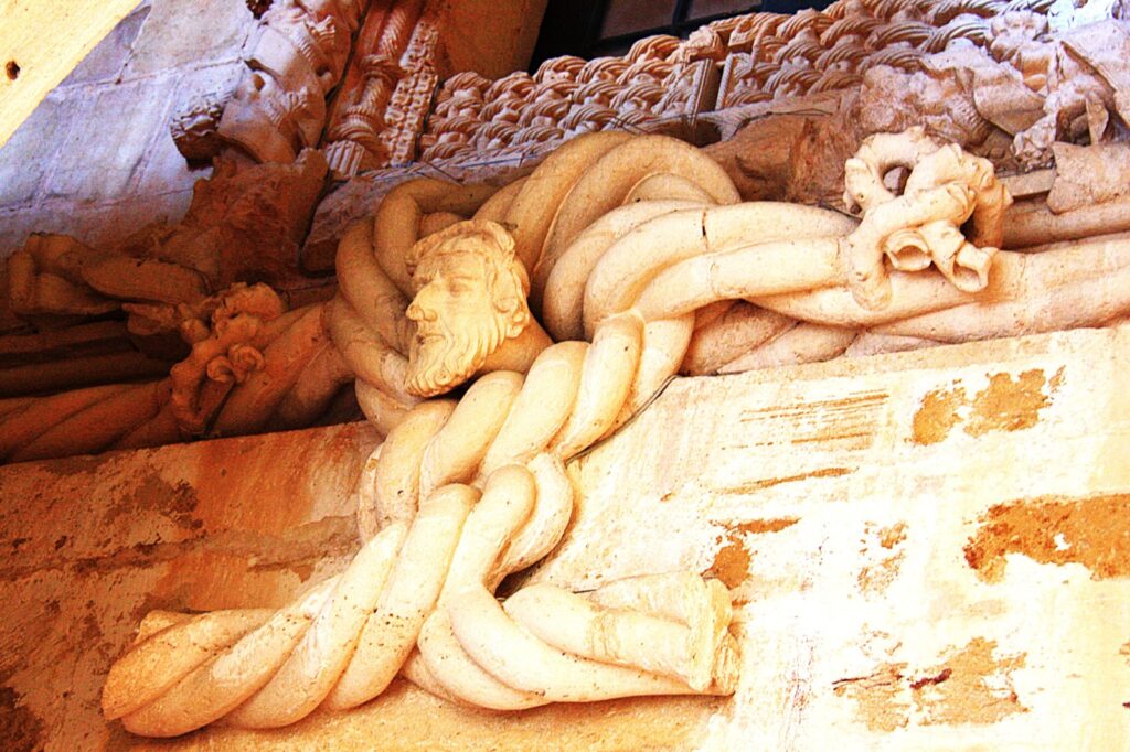 Intricate stone carving that is characteristic of the Manueline style, which is prominent in the Convent of Christ in Tomar, Portugal.