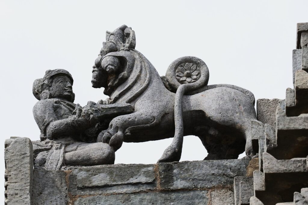 Mythical founder, Sala, stabbing a lion-like creature with a dagger - Emblem of Hoysala Empire