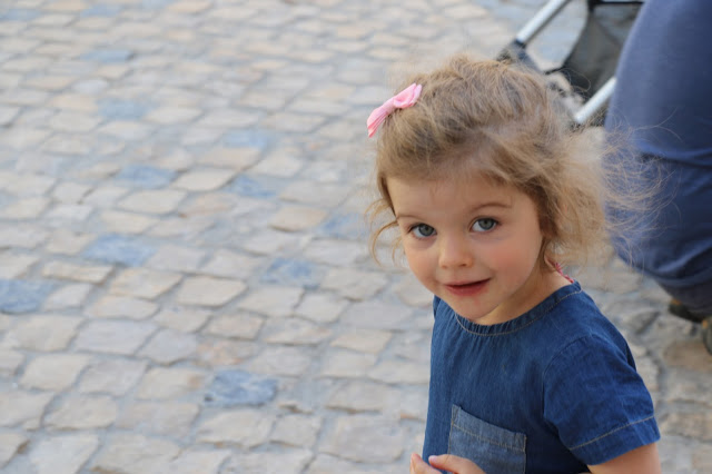 Curious little girl checking on what I am clicking on ground